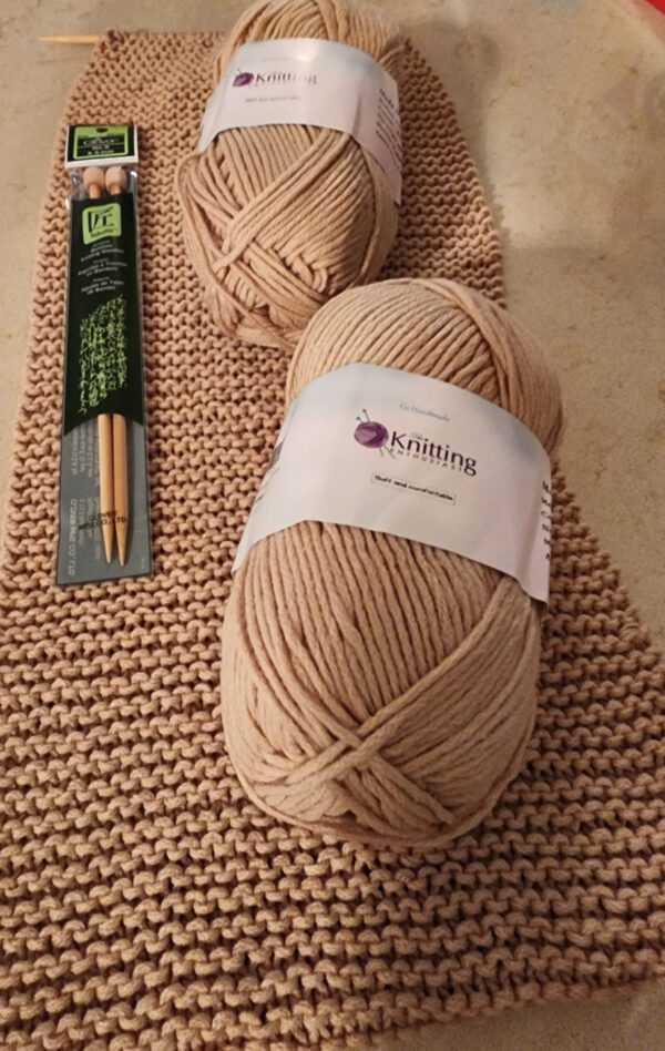 Beige knitting yarn with knitting needles